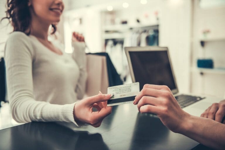 Girl Is Giving a Credit Card to Shop Assistant