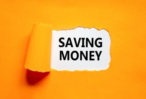 Concept words Saving money on beautiful white paper on a beautiful orange background.