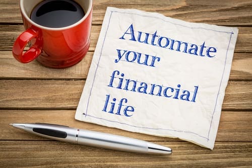Automate your financial life advice - handwriting on a napkin with a cup of espresso coffee.