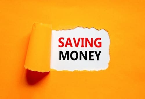 Saving money symbol. Concept words Saving money on beautiful white paper on a beautiful orange background.