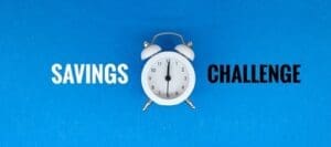 Savings Challenge on a blue background with a white alarm clock: Turn Small Changes into Big Financial Wins.