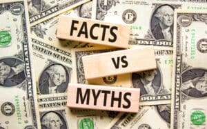 Facts vs myths symbol. Concept words Facts vs myths on wooden blocks on a beautiful background from dollar bills.