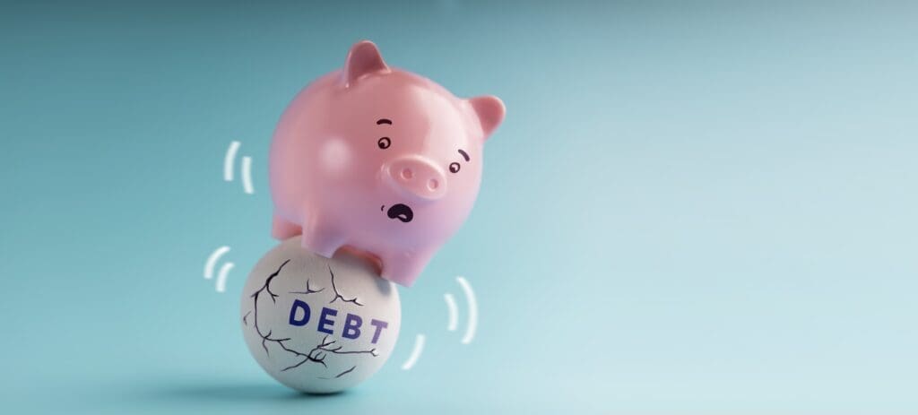 a Pink Piggy Bank in Shocked Face trying to balancing body on the Shaking Unstable Debt Ball